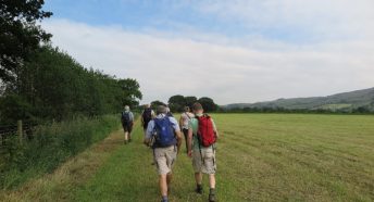 A group of people walking across a field