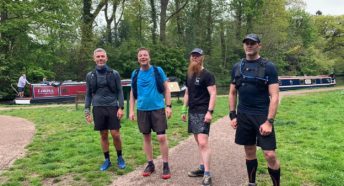 Four runners by a canal