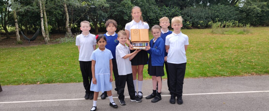 A group of children with a trophy