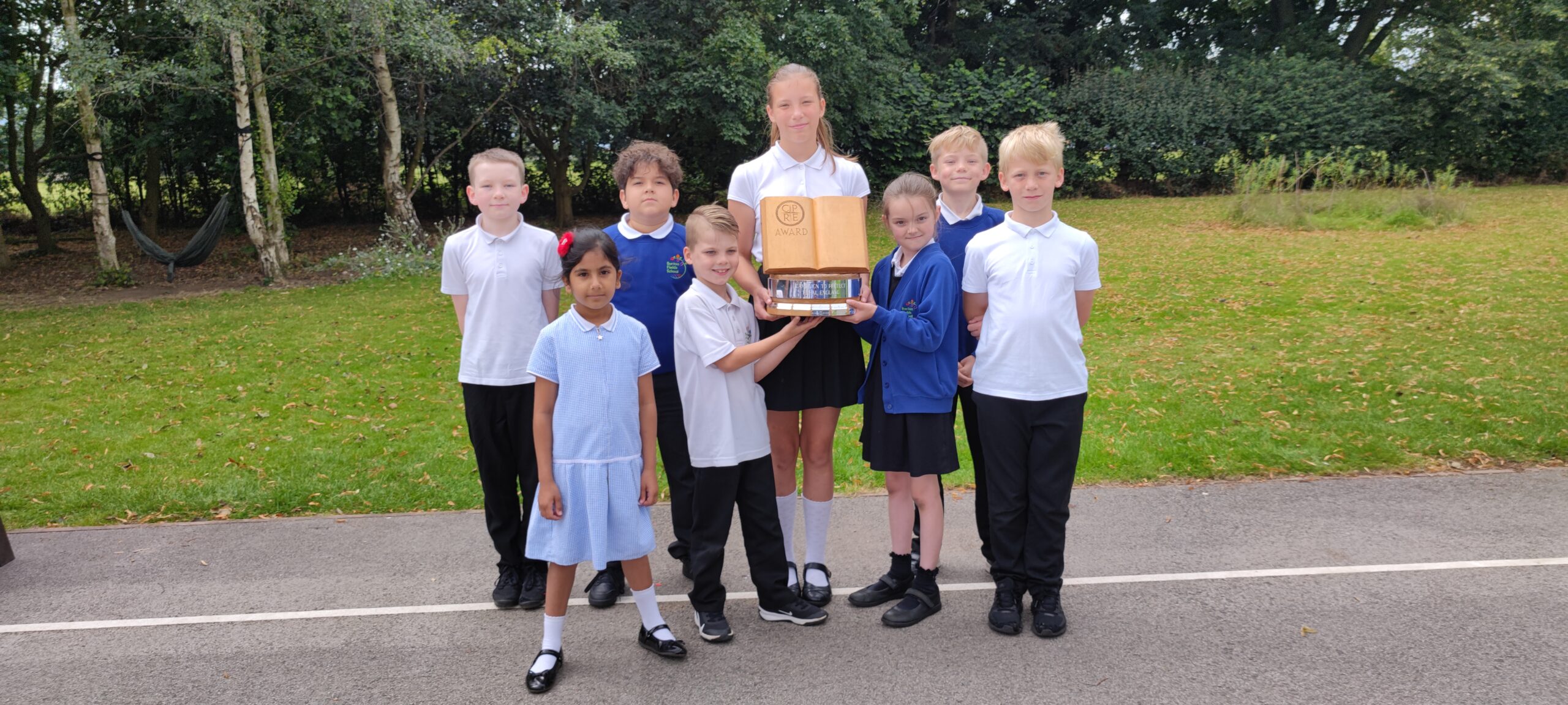 A group of children with a trophy