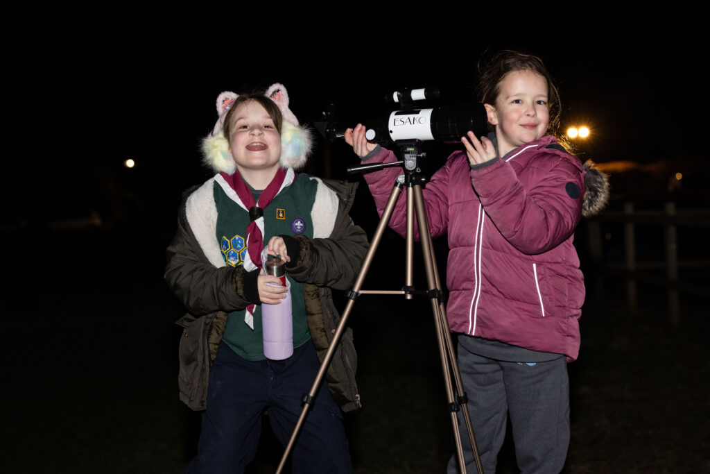 Two girls with a telescope